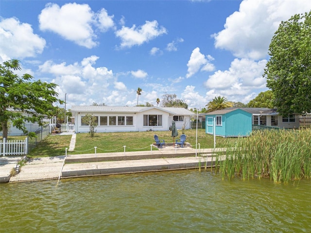 8014 Lotus Dr, Port Richey, FL 34668 - rear view of house featuring a water view and a shed