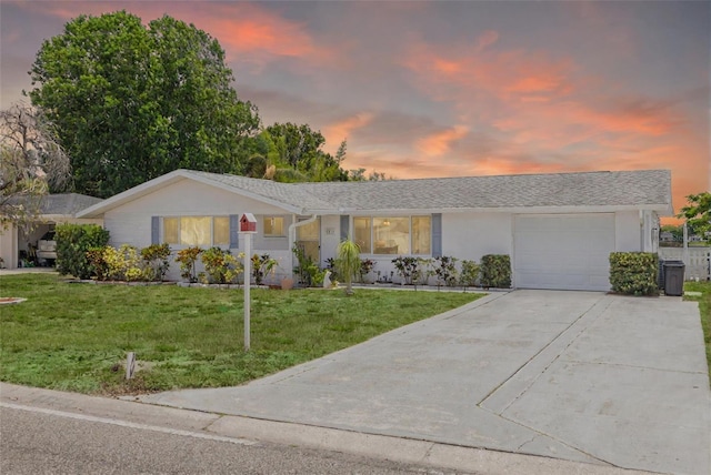 8014 Lotus Dr, Port Richey, FL 34668 - ranch-style home with an attached garage, driveway, a yard, and stucco siding