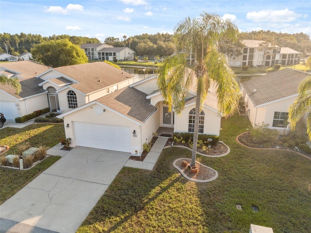 4411 Whitton Way, New Port Richey, FL 34653 - view of front of home featuring stucco siding, an attached garage, driveway, and a residential view