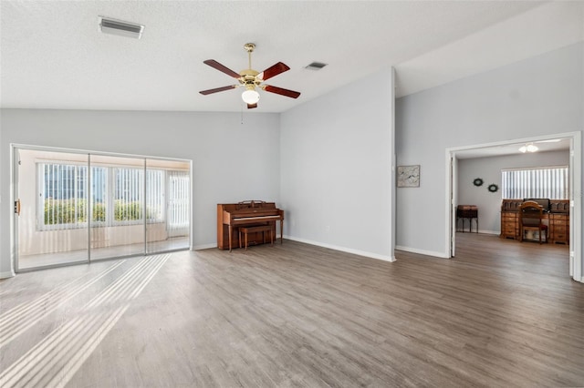 4411 Whitton Way, New Port Richey, FL 34653 - unfurnished living room with ceiling fan, wood finished floors, vaulted ceiling, and baseboards