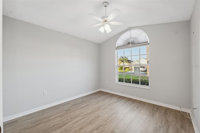 4411 Whitton Way, New Port Richey, FL 34653 - unfurnished room with wood finished floors, lofted ceiling, baseboards, and ceiling fan