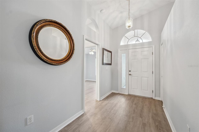 4411 Whitton Way, New Port Richey, FL 34653 - foyer with wood finished floors, baseboards, a chandelier, and a ceiling fan