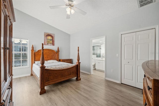 4411 Whitton Way, New Port Richey, FL 34653 - bedroom with light wood finished floors, lofted ceiling, baseboards, connected bathroom, and a ceiling fan