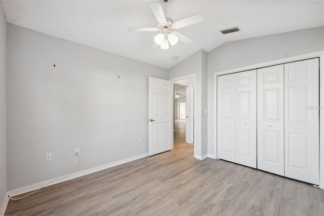 4411 Whitton Way, New Port Richey, FL 34653 - unfurnished bedroom with wood finished floors, vaulted ceiling, baseboards, a closet, and ceiling fan
