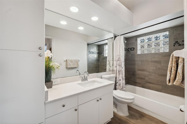 4411 Whitton Way, New Port Richey, FL 34653 - bathroom with toilet, vanity, shower / tub combo, wood finished floors, and recessed lighting