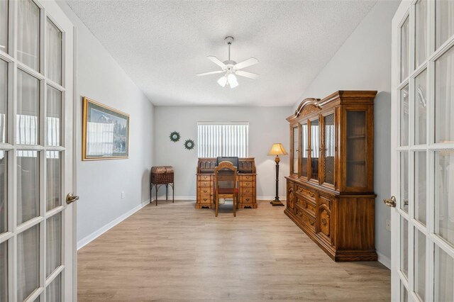 4411 Whitton Way, New Port Richey, FL 34653 - office space featuring french doors, a textured ceiling, light wood-style flooring, ceiling fan, and baseboards