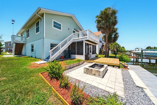 3312 Holly Springs Dr, Hernando Beach, FL 34607 - back of house with a fire pit, a patio, a sunroom, stairway, and a lawn