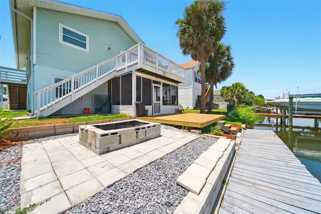 3312 Holly Springs Dr, Hernando Beach, FL 34607 - rear view of house with a patio, a sunroom, boat lift, and a wooden deck