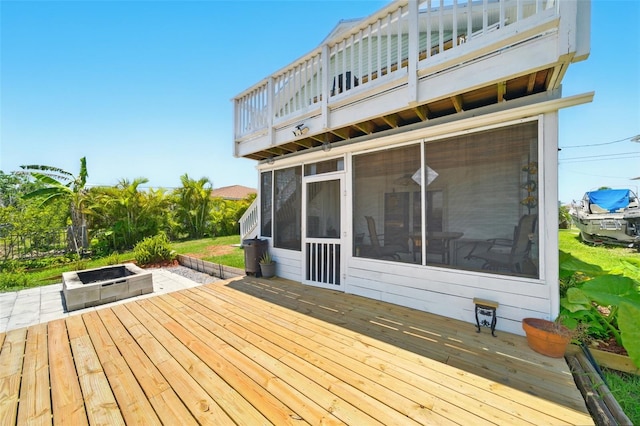 3312 Holly Springs Dr, Hernando Beach, FL 34607 - wooden deck with a sunroom and a fire pit