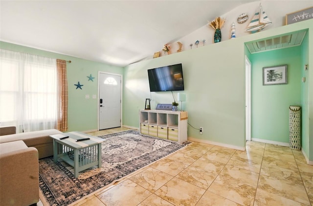 3312 Holly Springs Dr, Hernando Beach, FL 34607 - living area with lofted ceiling, marble finish flooring, and baseboards