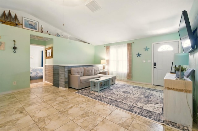3312 Holly Springs Dr, Hernando Beach, FL 34607 - living room featuring lofted ceiling, marble look tiles, and baseboards