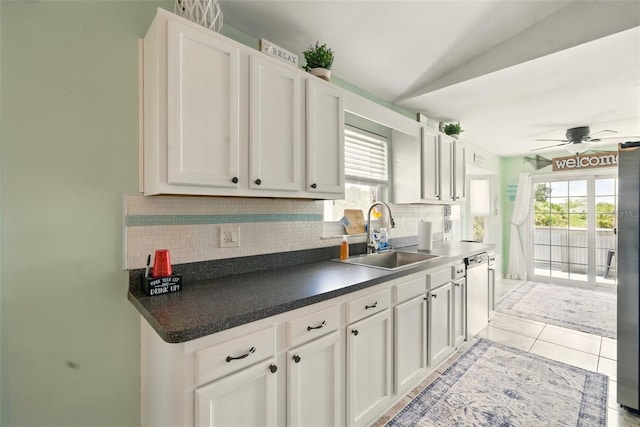 3312 Holly Springs Dr, Hernando Beach, FL 34607 - kitchen featuring a sink, stainless steel dishwasher, tasteful backsplash, a ceiling fan, and plenty of natural light