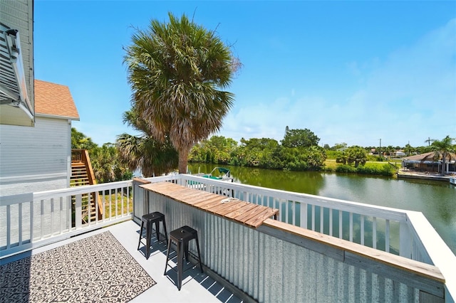 3312 Holly Springs Dr, Hernando Beach, FL 34607 - wooden terrace with a water view and stairway