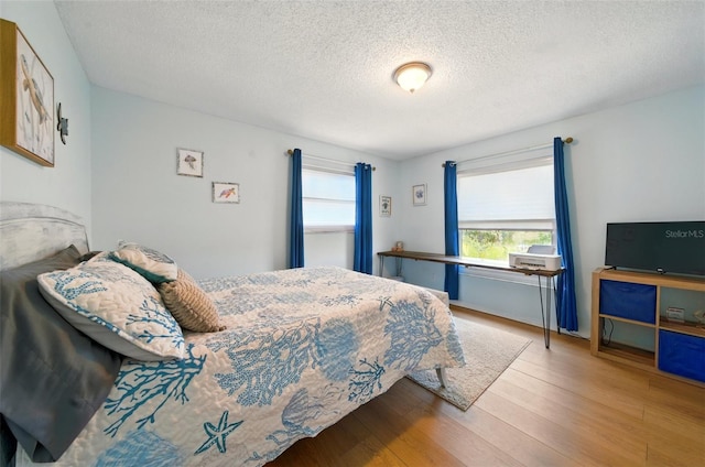 3312 Holly Springs Dr, Hernando Beach, FL 34607 - bedroom featuring a textured ceiling and wood finished floors