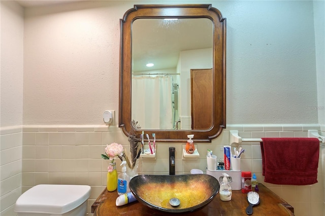 18121 Geraci Rd, Lutz, FL 33548 - bathroom with tile walls, toilet, wainscoting, and vanity