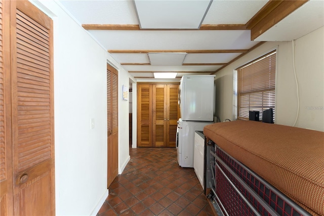 18121 Geraci Rd, Lutz, FL 33548 - kitchen featuring stacked washing machine and dryer and dark tile patterned flooring