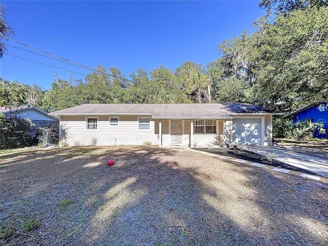 1585 W J Williams Ln, Dunnellon, FL 34434 - ranch-style home with concrete driveway, a garage, and a porch
