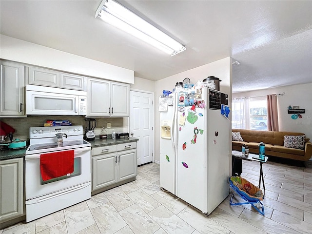 1585 W J Williams Ln, Dunnellon, FL 34434 - kitchen with white appliances, dark countertops, and open floor plan