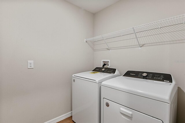 1221 Tidal St, Haines City, FL 33844 - laundry room featuring separate washer and dryer, baseboards, and light wood-type flooring