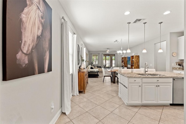 18620 Rococo Rd, Spring Hill, FL 34610 - kitchen with a sink, dishwasher, white cabinets, open floor plan, and light tile patterned floors