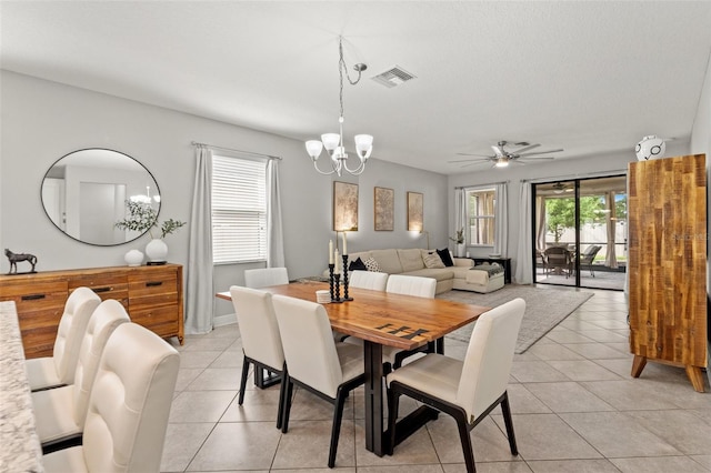 18620 Rococo Rd, Spring Hill, FL 34610 - dining area featuring light tile patterned flooring, ceiling fan, and a chandelier