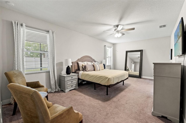 18620 Rococo Rd, Spring Hill, FL 34610 - bedroom featuring light carpet, baseboards, a ceiling fan, and a textured ceiling
