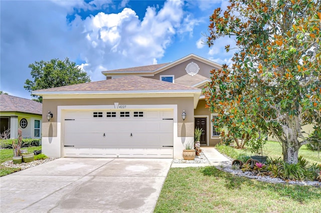 4227 Bethpage Ct, Wesley Chapel, FL 33543 - view of front of property featuring stucco siding, an attached garage, concrete driveway, and roof with shingles