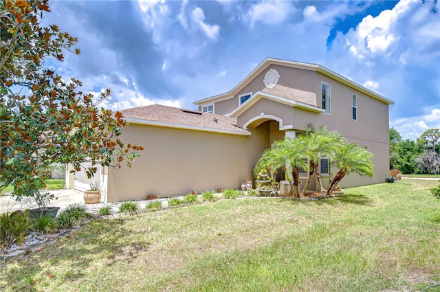 4227 Bethpage Ct, Wesley Chapel, FL 33543 - view of front of house with stucco siding, a front yard, and roof with shingles
