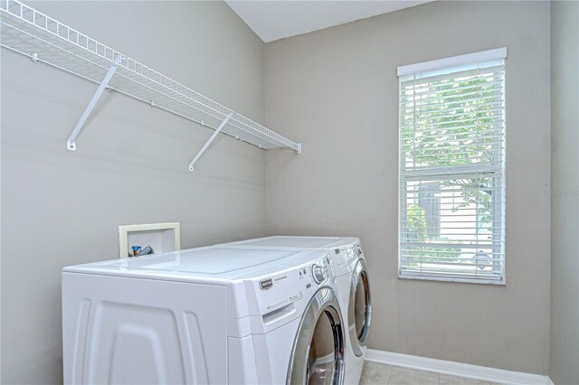 4227 Bethpage Ct, Wesley Chapel, FL 33543 - laundry room with washing machine and dryer, healthy amount of natural light, baseboards, and light tile patterned floors