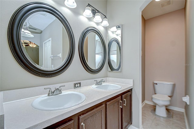 4227 Bethpage Ct, Wesley Chapel, FL 33543 - bathroom featuring double vanity, toilet, tile patterned flooring, and baseboards