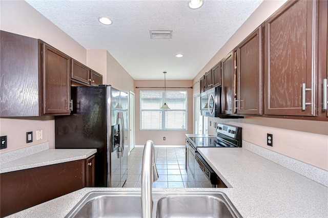 4227 Bethpage Ct, Wesley Chapel, FL 33543 - kitchen featuring appliances with stainless steel finishes, a sink, light countertops, tile patterned flooring, and recessed lighting