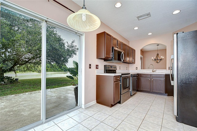 4227 Bethpage Ct, Wesley Chapel, FL 33543 - kitchen featuring appliances with stainless steel finishes, light tile patterned floors, a chandelier, light countertops, and recessed lighting