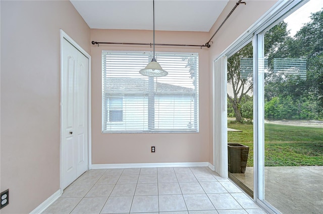 4227 Bethpage Ct, Wesley Chapel, FL 33543 - unfurnished dining area with light tile patterned flooring and baseboards