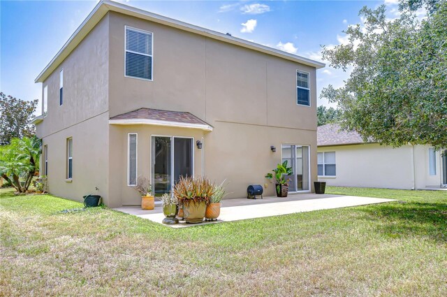 4227 Bethpage Ct, Wesley Chapel, FL 33543 - rear view of property with a patio area, stucco siding, and a yard