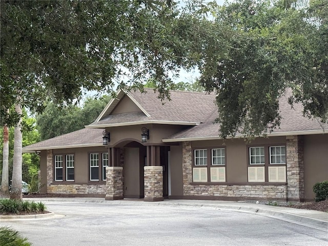 4227 Bethpage Ct, Wesley Chapel, FL 33543 - view of front of property with stone siding, stucco siding, and roof with shingles