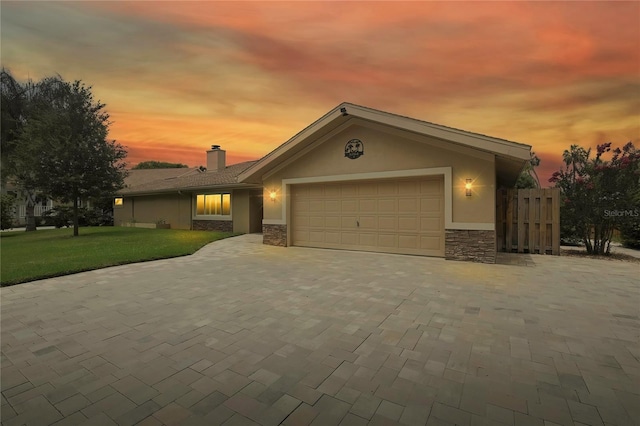 5264 S Spy Glass Pt, Homosassa, FL 34448 - view of front of property with stone siding, a garage, stucco siding, driveway, and a chimney