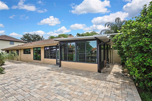 5264 S Spy Glass Pt, Homosassa, FL 34448 - rear view of property with a sunroom, a chimney, a patio area, and stucco siding