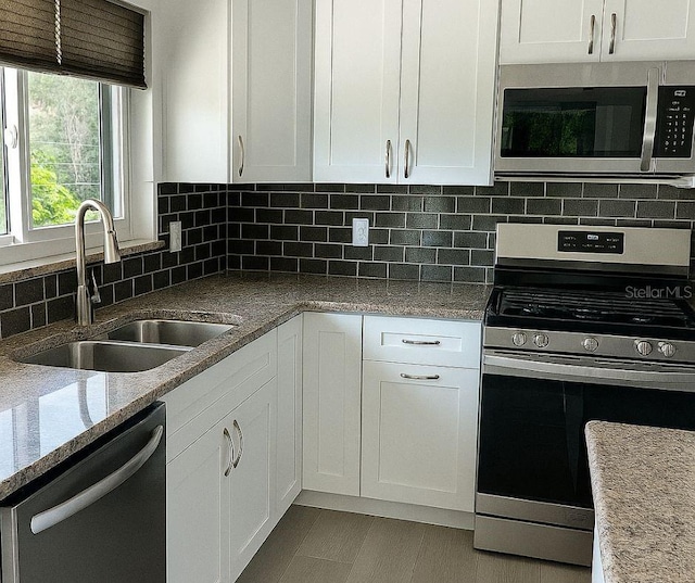 5264 S Spy Glass Pt, Homosassa, FL 34448 - kitchen featuring appliances with stainless steel finishes, white cabinetry, and decorative backsplash