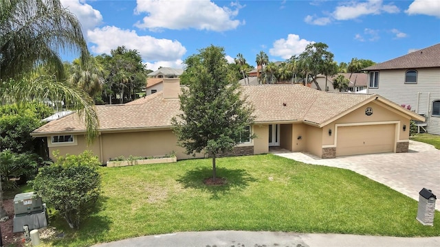 5264 S Spy Glass Pt, Homosassa, FL 34448 - view of front of home featuring stucco siding, a garage, decorative driveway, a front yard, and stone siding