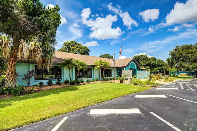 5264 S Spy Glass Pt, Homosassa, FL 34448 - view of front facade with uncovered parking, a front lawn, and stucco siding