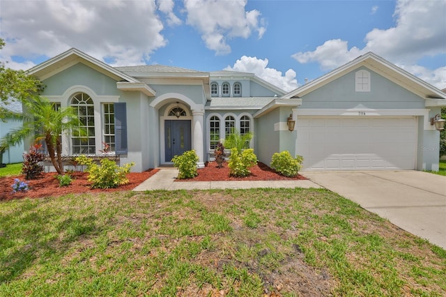 7114 Cromwell Park Ln, Apollo Beach, FL 33572 - view of front of property featuring driveway, a garage, stucco siding, and a front yard
