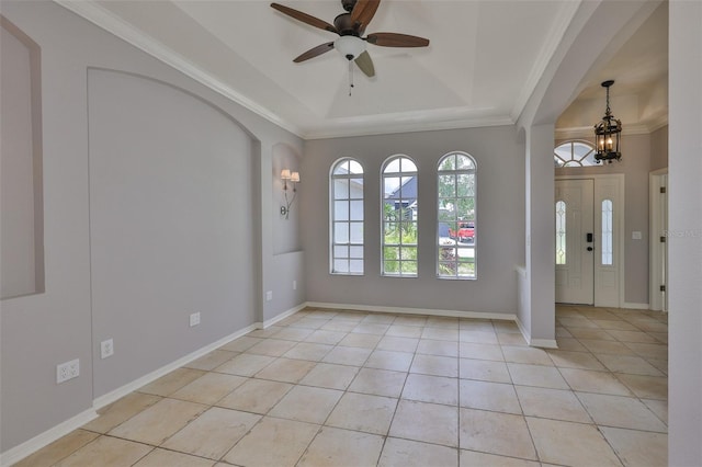 7114 Cromwell Park Ln, Apollo Beach, FL 33572 - foyer entrance with light tile patterned flooring, a ceiling fan, a raised ceiling, a chandelier, and ornamental molding
