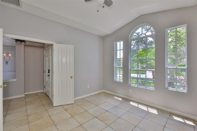 7114 Cromwell Park Ln, Apollo Beach, FL 33572 - spare room with vaulted ceiling, light tile patterned flooring, a ceiling fan, and baseboards
