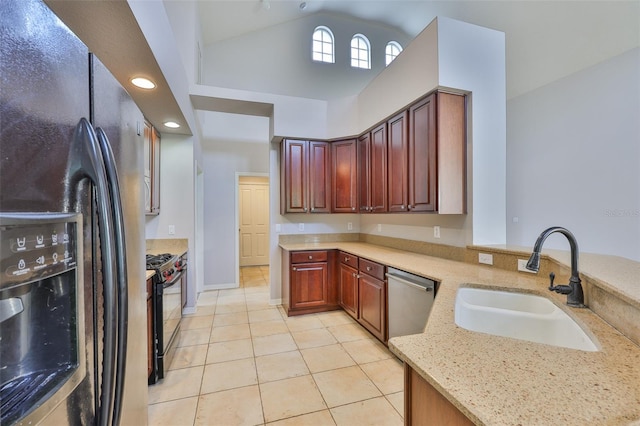 7114 Cromwell Park Ln, Apollo Beach, FL 33572 - kitchen with black appliances, a sink, light tile patterned flooring, light stone counters, and a peninsula