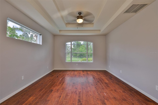 7114 Cromwell Park Ln, Apollo Beach, FL 33572 - empty room with a raised ceiling, dark wood finished floors, a ceiling fan, and baseboards