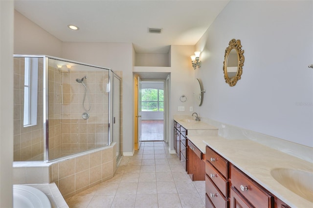 7114 Cromwell Park Ln, Apollo Beach, FL 33572 - bathroom with vanity, a shower stall, tile patterned flooring, and a garden tub