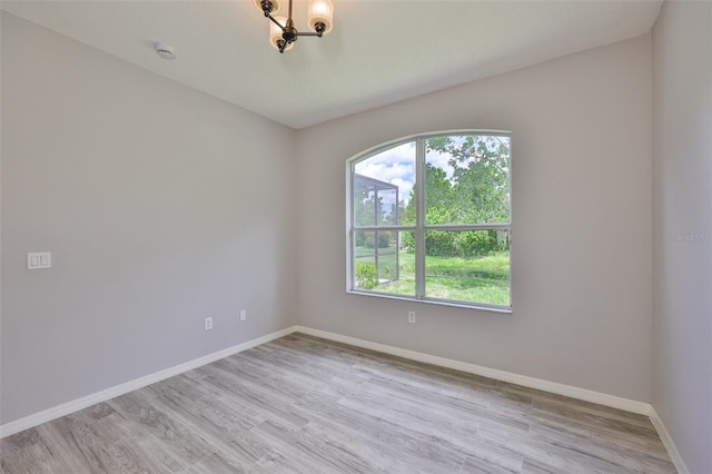 7114 Cromwell Park Ln, Apollo Beach, FL 33572 - unfurnished room with healthy amount of natural light, baseboards, and light wood-style floors