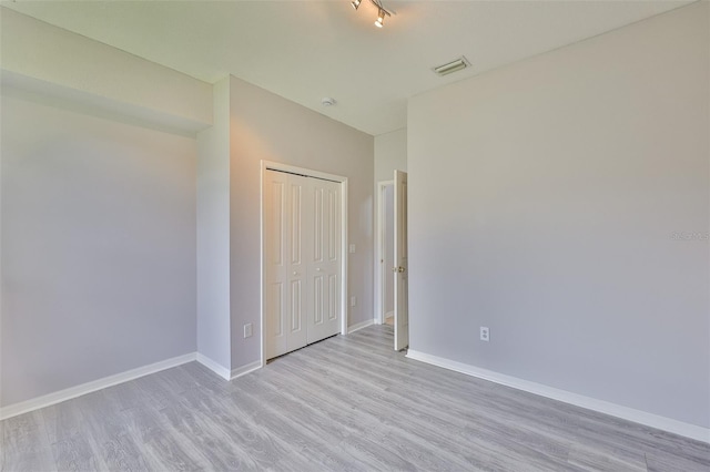 7114 Cromwell Park Ln, Apollo Beach, FL 33572 - unfurnished bedroom with light wood finished floors, baseboards, and a closet