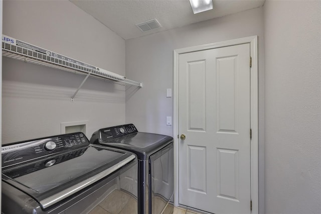7114 Cromwell Park Ln, Apollo Beach, FL 33572 - laundry room with washing machine and dryer and light tile patterned floors