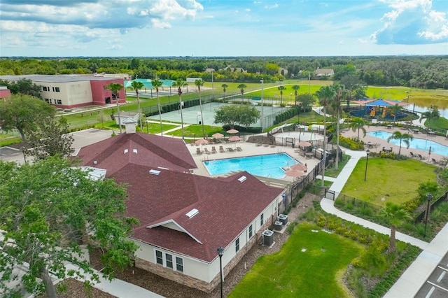 7114 Cromwell Park Ln, Apollo Beach, FL 33572 - bird's eye view of a pool area, a tree filled landscape, and a large body of water